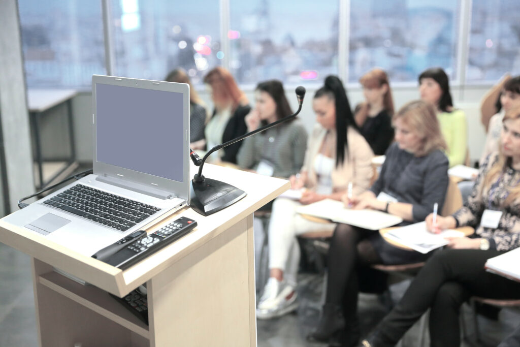 A group of female employees going through a workplace safety training in a conference room