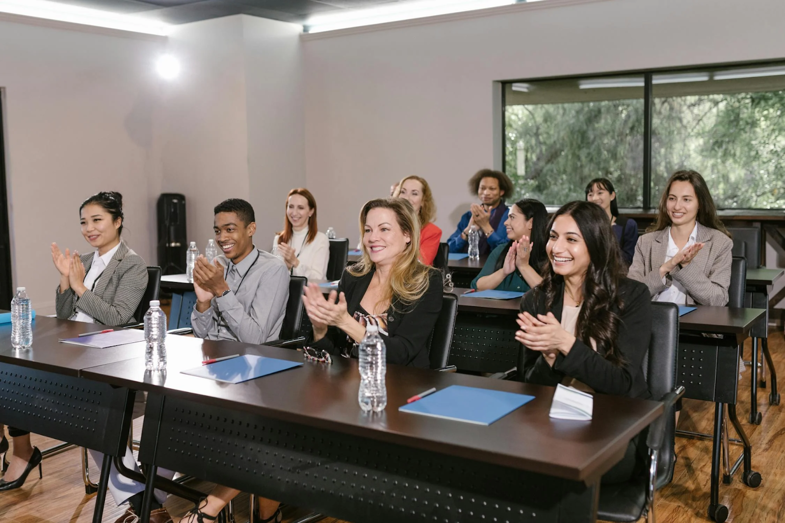 Coworkers in a conference room sit through a DEI training