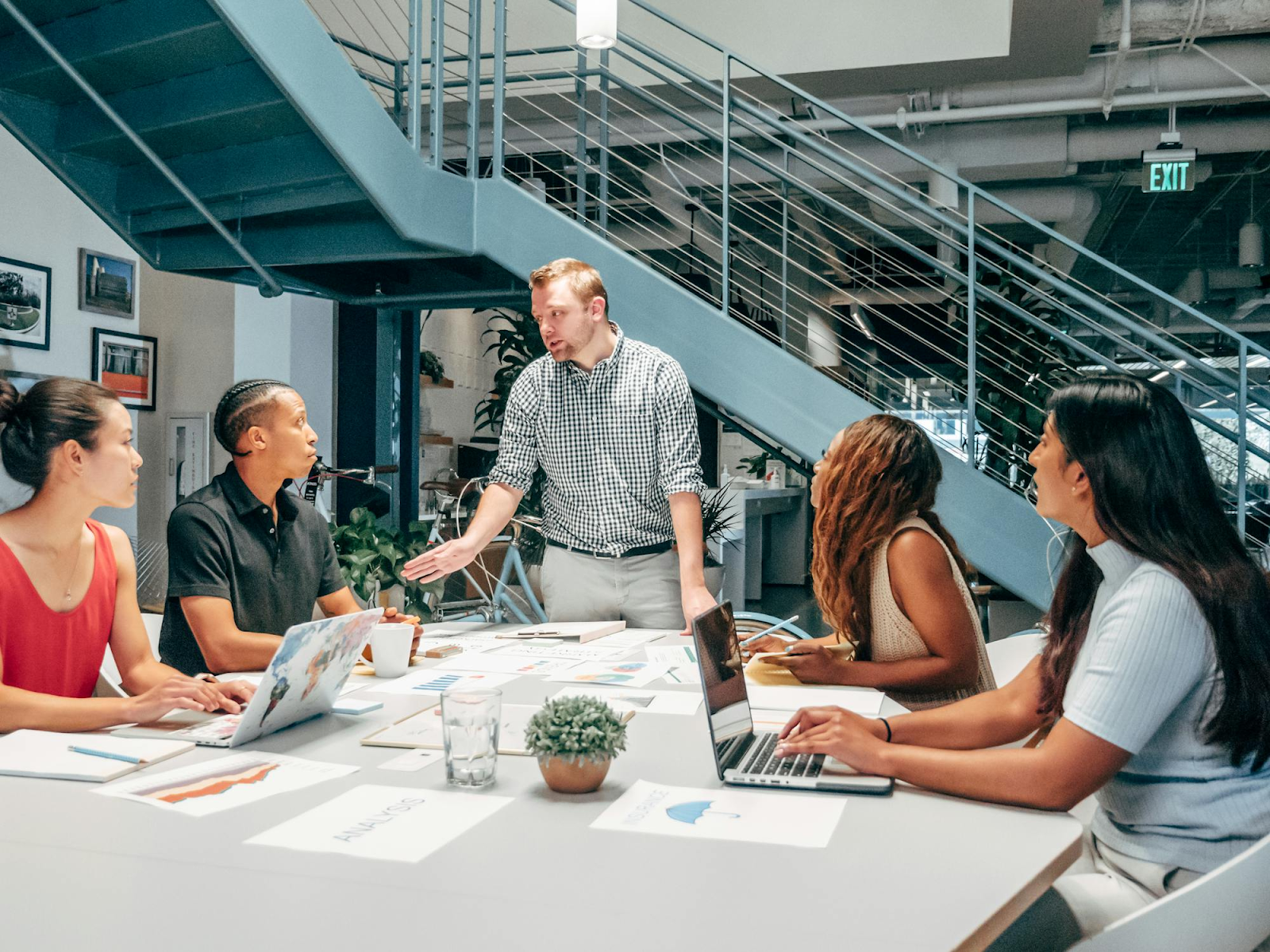 A man leads a work meeting in the office