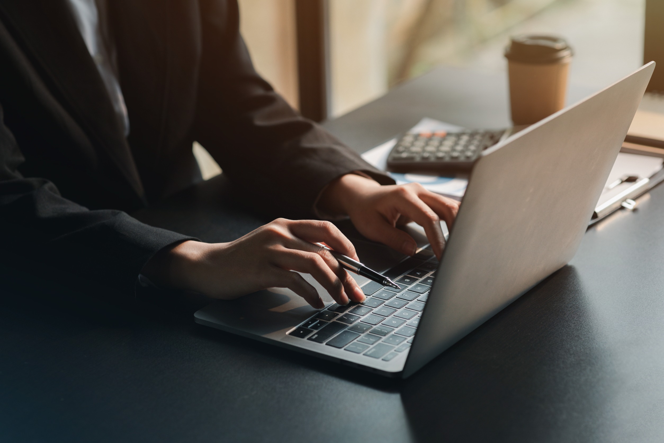 Close-up Of A Business Professional's Hands Typing On A Laptop, Analyzing Financial Data