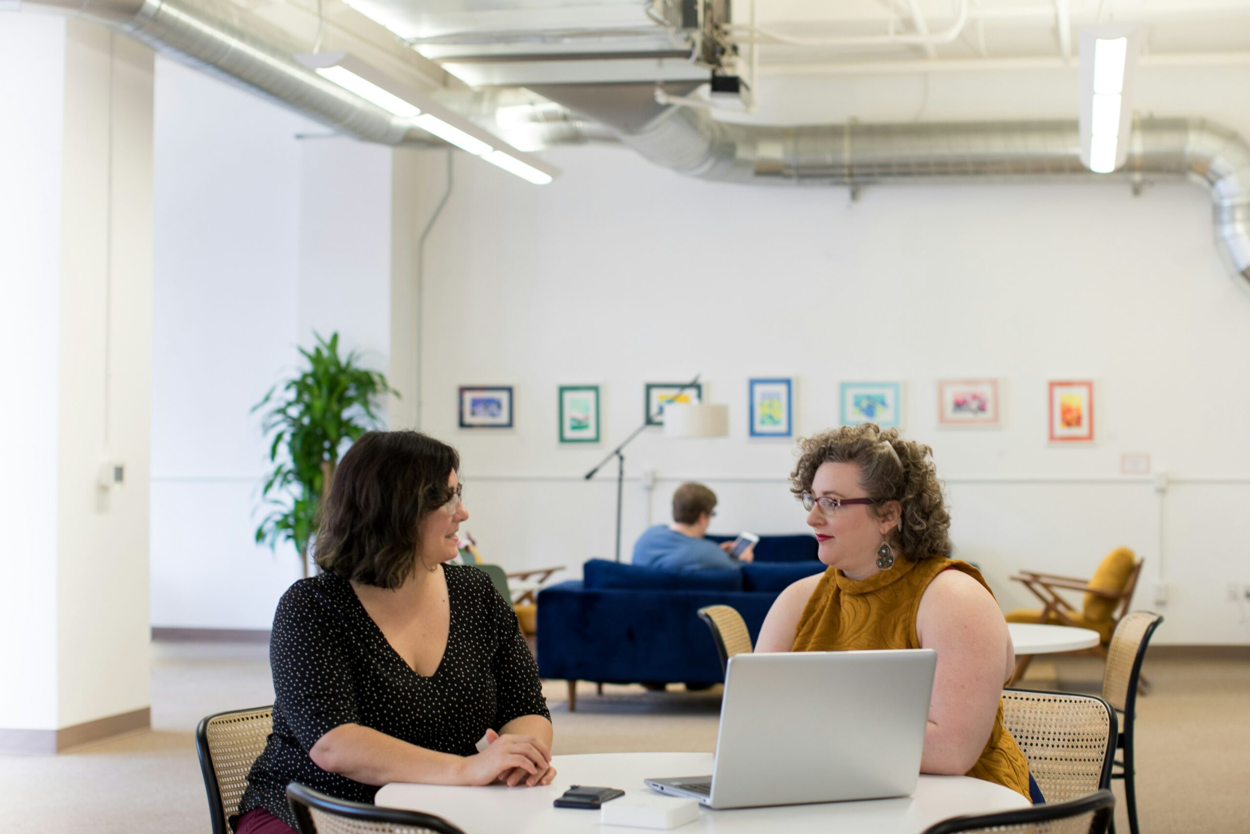 Women At A Table With A Laptop Working On HR Certification Courses Online